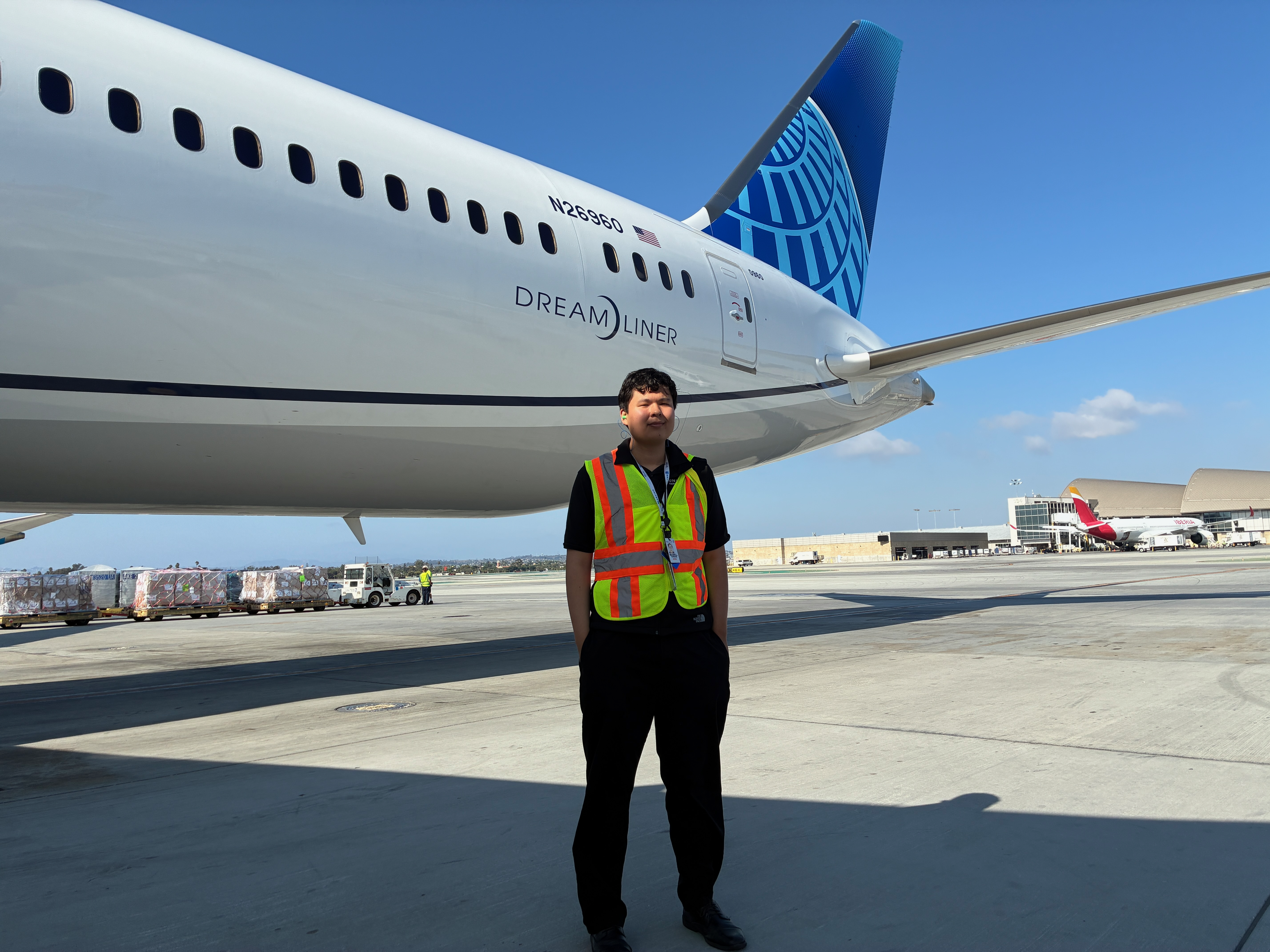 Maxwell Turnage stands infront of United Airlines aircraft at LAX airport.